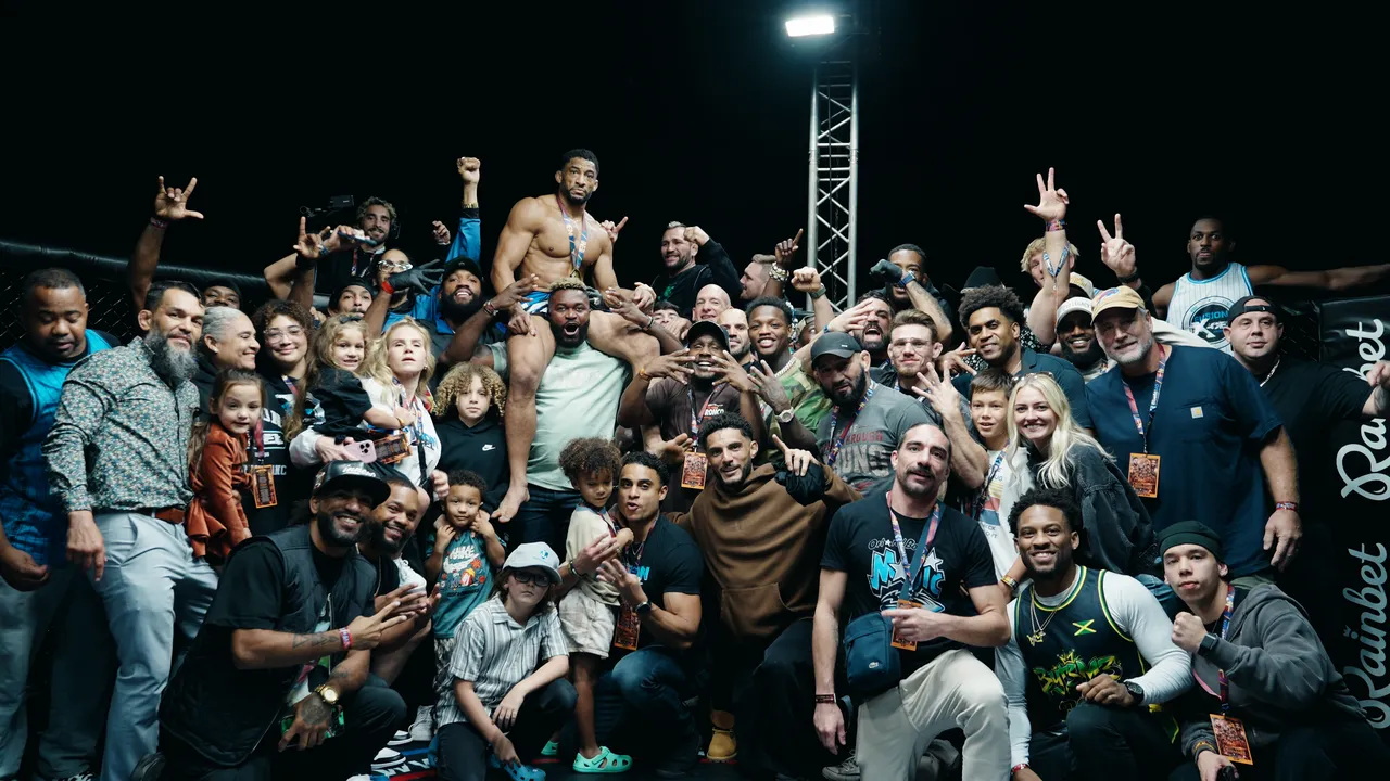 Julien Williams with family and team gathered in the cage after the fight
