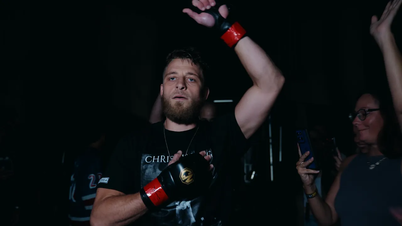 John Morea walking out with an arm raised