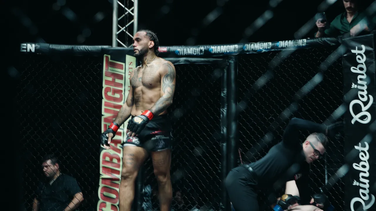 Eddie PerezBruno standing in the cage after the stoppage, the referee attending to Tyler Keating