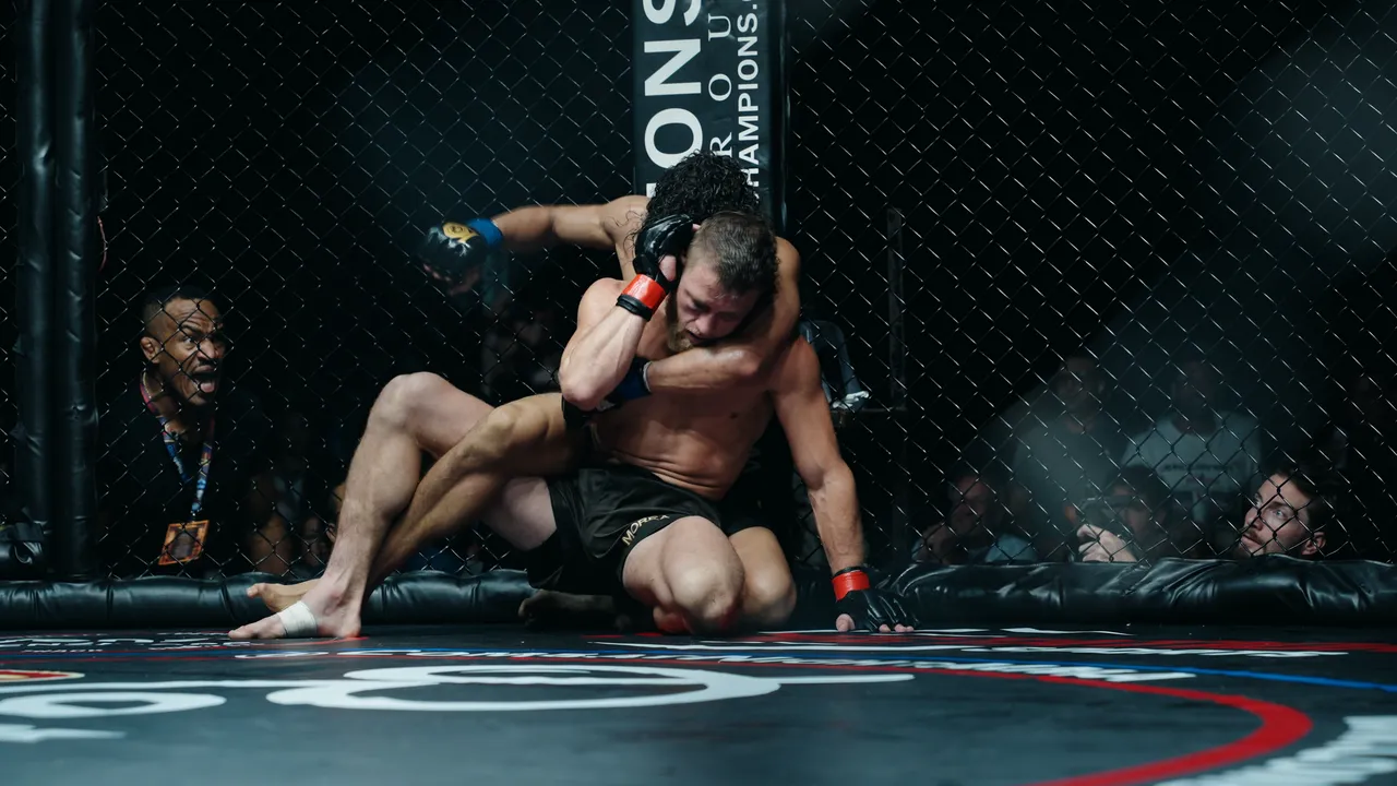 EJ Hernandez on John Morea's back with an arm across Morea's neck at the fence