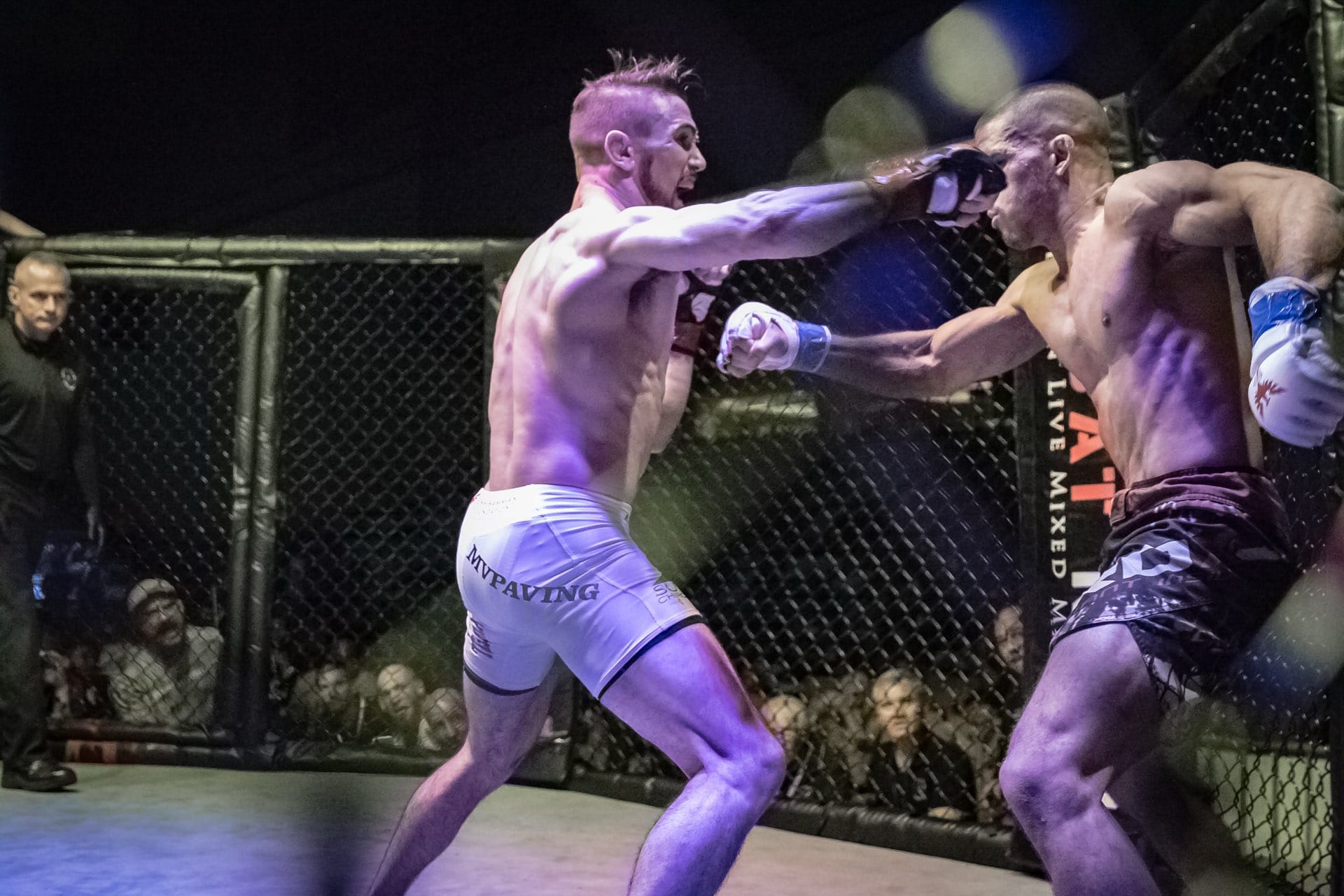 A Combat Night fighter launches a flying strike inside the cage