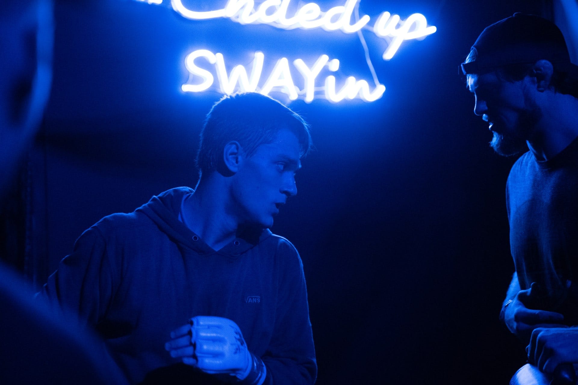 A Combat Night fighter making the walkout under neon arena lights before a bout